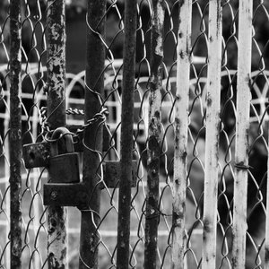 Rusty locked gate gate fence