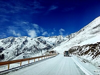 Blue sky snow mountain road photo