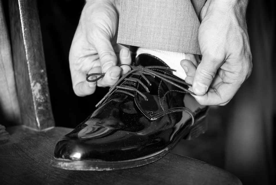 Tying shoe man wedding shoes