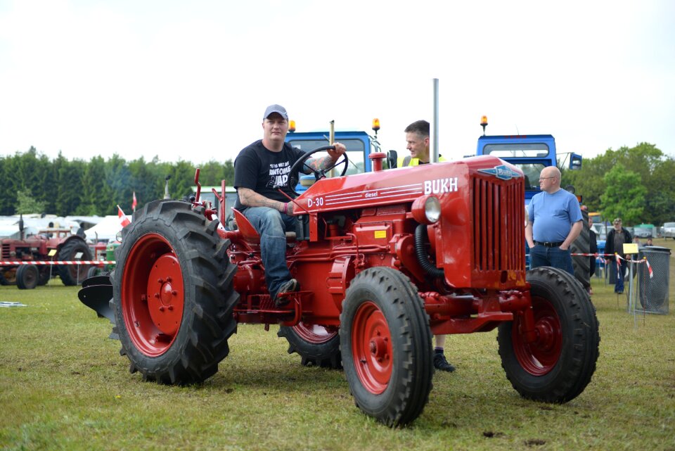 Man on tractor red tractor old tractor