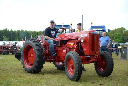 Man on tractor red tractor old tractor photo