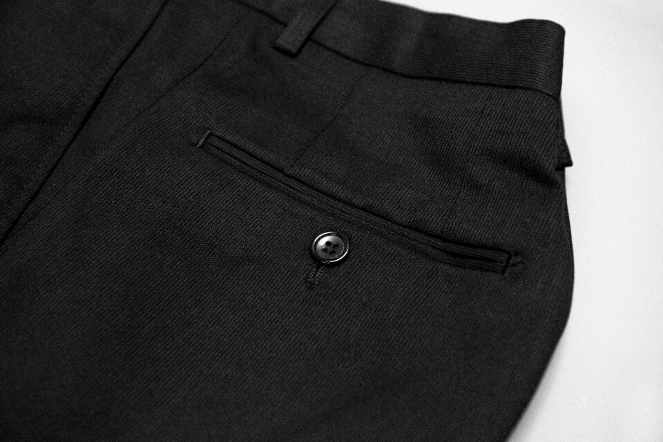 Suit pants pocket button