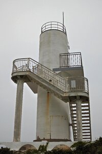 Lighthouse coast partly cloudy