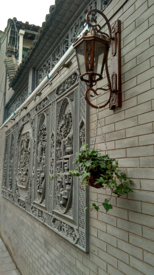 Wall sconce brick wall green plants