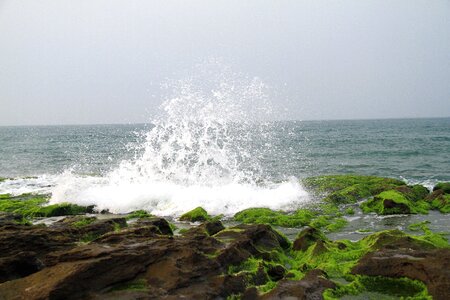 Green stone trough rocky shore erosion photo