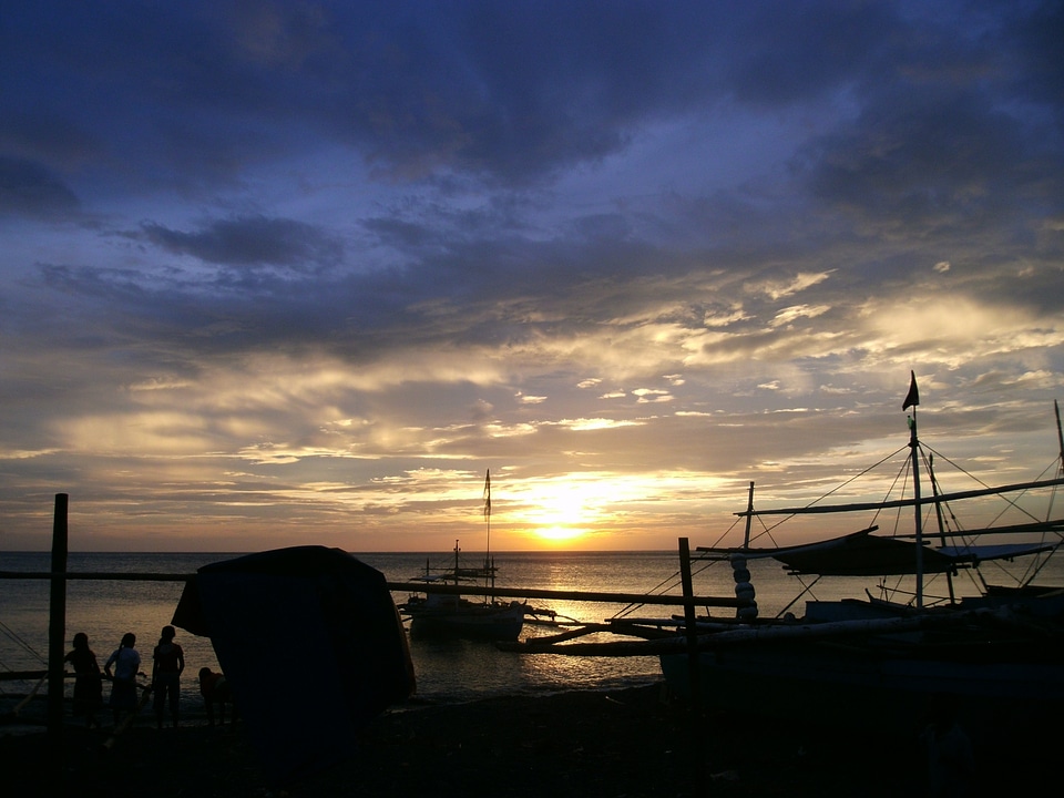 Beach sunset fishermen