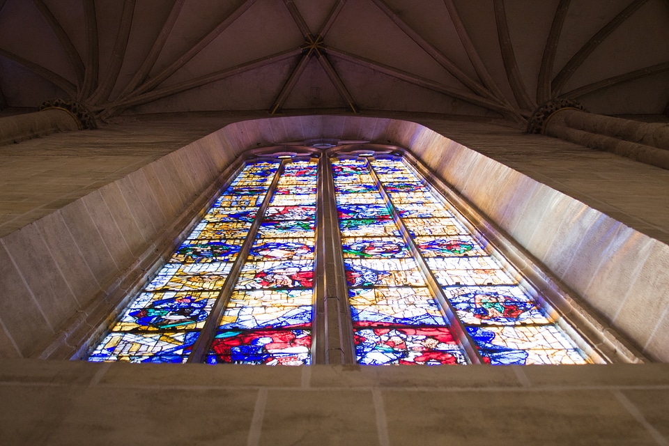 Church window view from below stained glass window