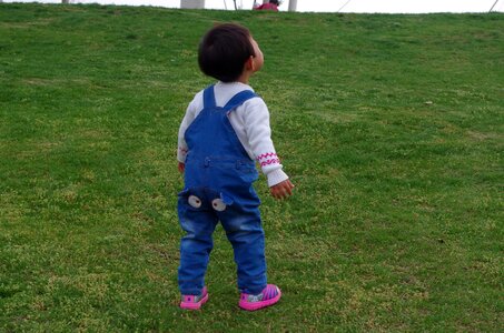 Figure look up to the sky flying a kite