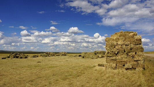 Prairie haystack blue sky and white clouds