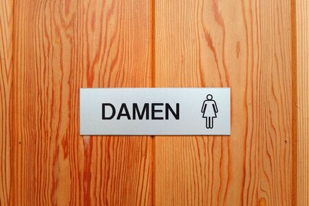 Toilet door woman