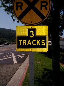 Sign post tracks of rails photo