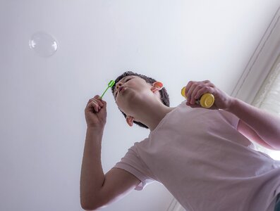 Soap child blowing bubbles photo