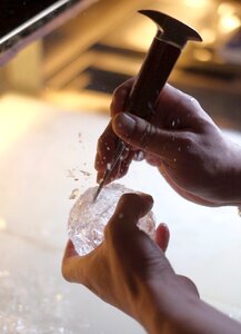 Hands bartender ice chips
