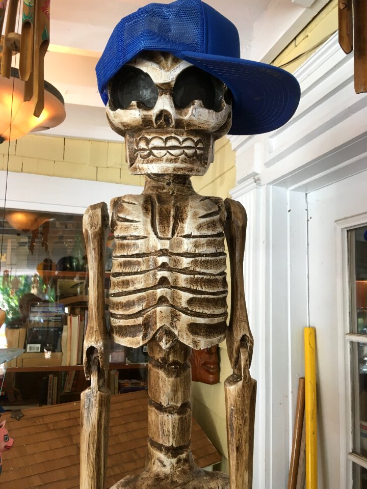 Artificial sculpture with blue hat skeleton with hat