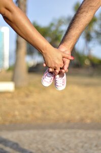 Hand holding maternity photo