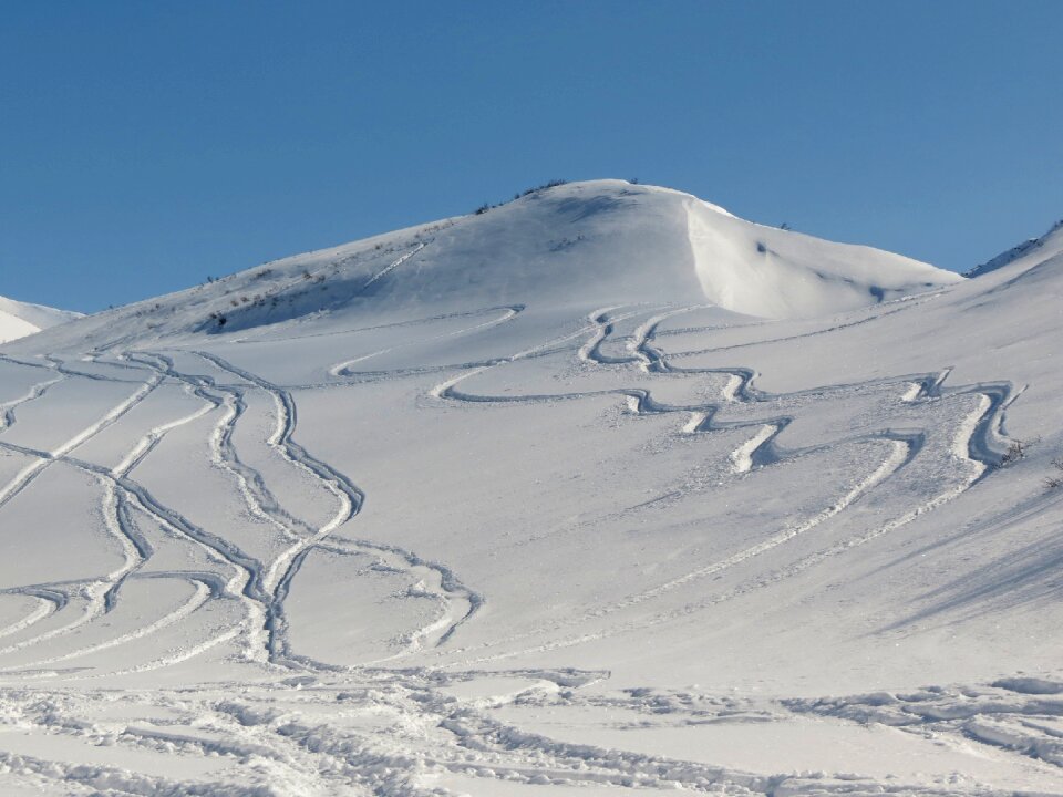 Travel by snowmobile footprints in the snow mountains photo