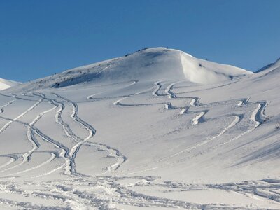 Travel by snowmobile footprints in the snow mountains