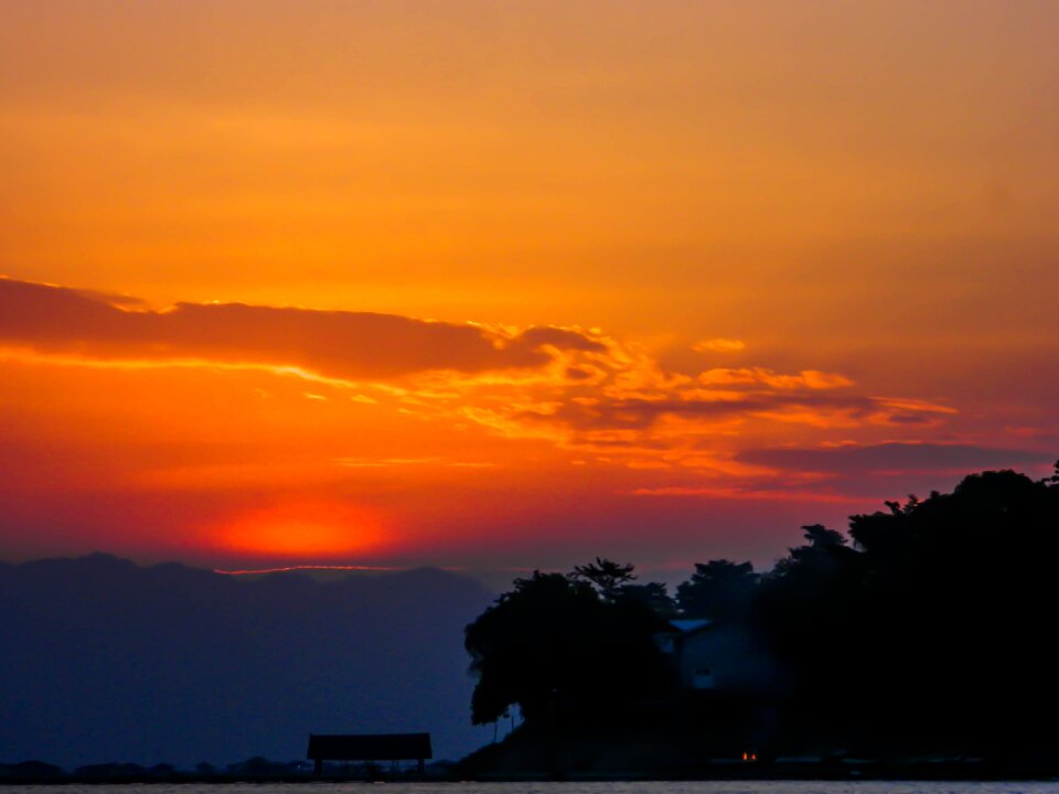 Sunset behind hill photo