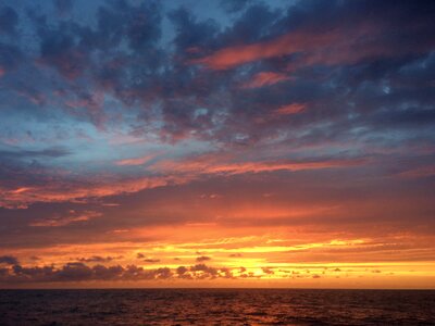 Setting sun colored air sea