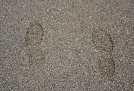 Beige wet sand footprints shoes photo