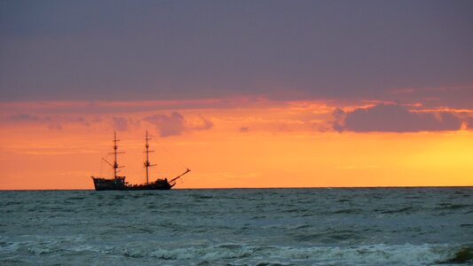 Sea ship sunset photo