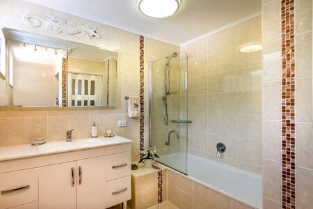 Beige tiles brown bathroom photo