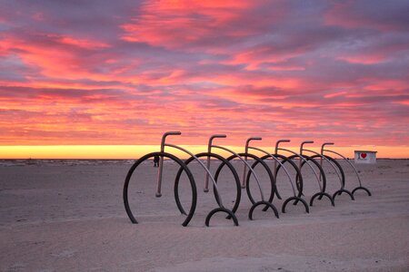 Clouds bicycles sand photo