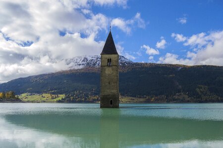 Clock tower sunken church reschen pass photo