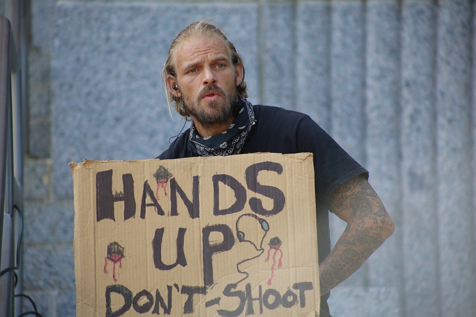 Scruffy hands up sign