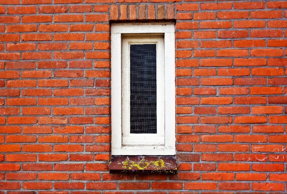 Narrow window white window brick wall