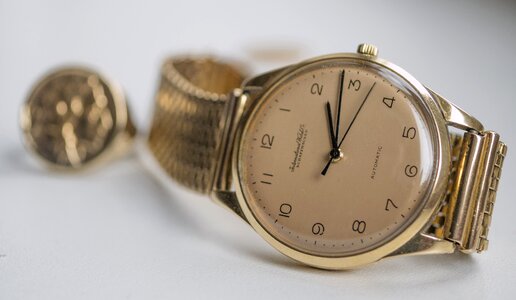 Golden background wrist watch photo