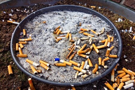 Public ash tray cigarette cigarette butt photo