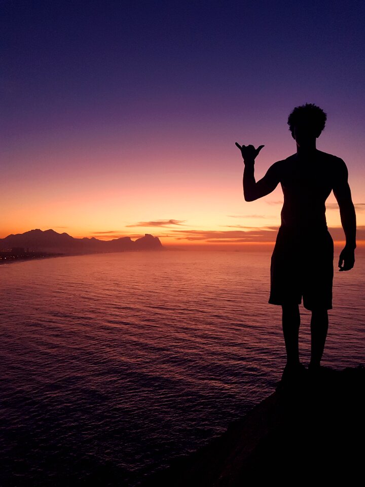 Silhouette dawn body of water