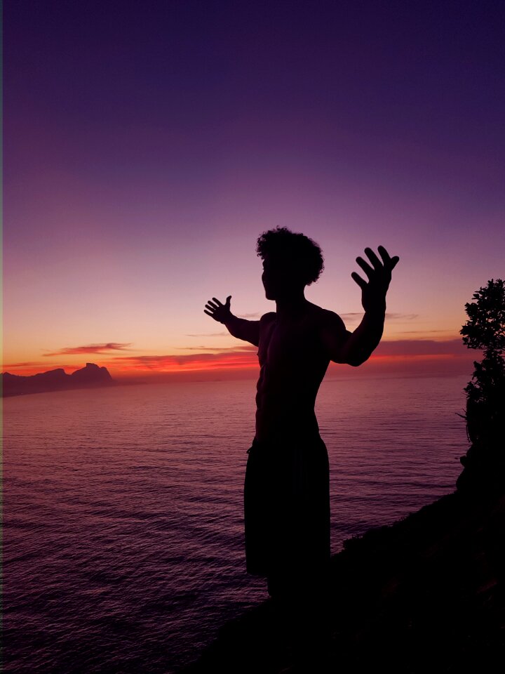 People silhouette body of water