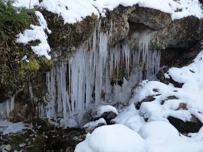 Waterfall frozen mountain stream photo