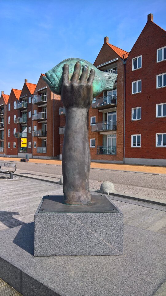 Modern metal sculpture on granite base arm