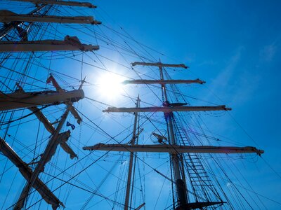 Distant port sailing boat photo