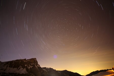 Alpine night sky rotation of the earth photo