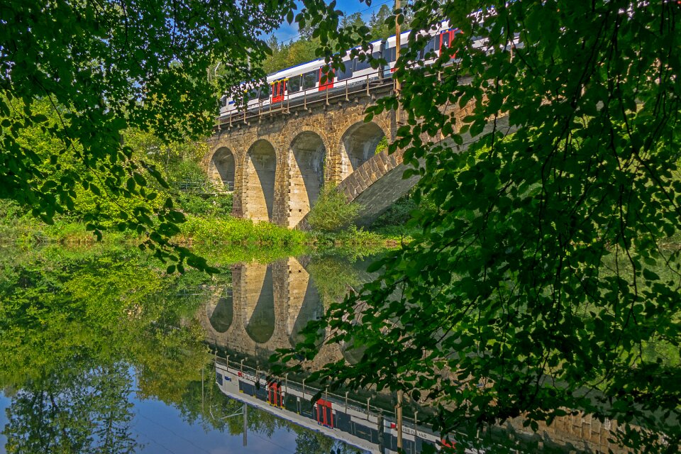 Train travel bridge mirroring photo