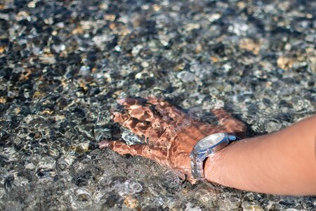 Hand pebbles underwater