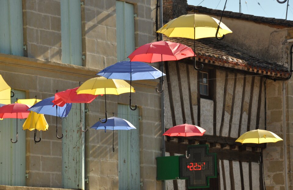 Umbrellas village street sun