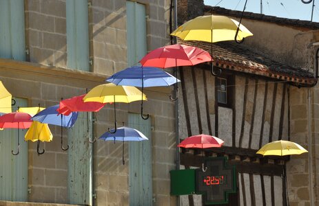 Umbrellas village street sun