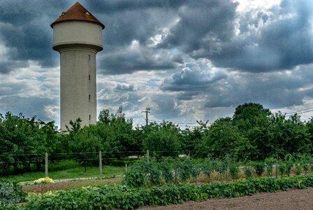 Water tower vegetable garden nature photo