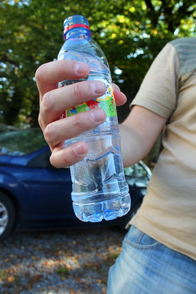 Plastic bottle bottle in hand the water in the bottle
