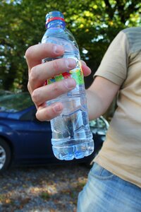 Plastic bottle bottle in hand the water in the bottle