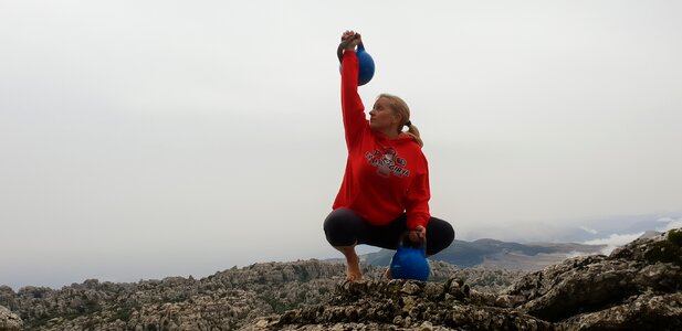 Kettlebell woman mountain kettlebell trainer photo