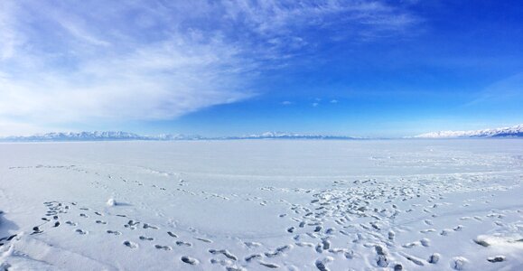 Snow footprints blue sky