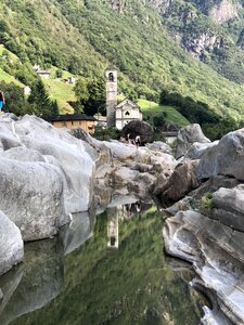 Church reflection mountain river