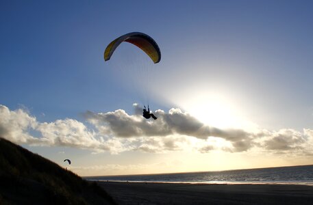 Paragliding backlighting clouds