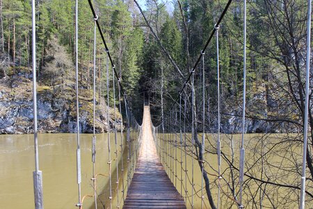 Suspension bridge the rope bridge the bridge over the river photo